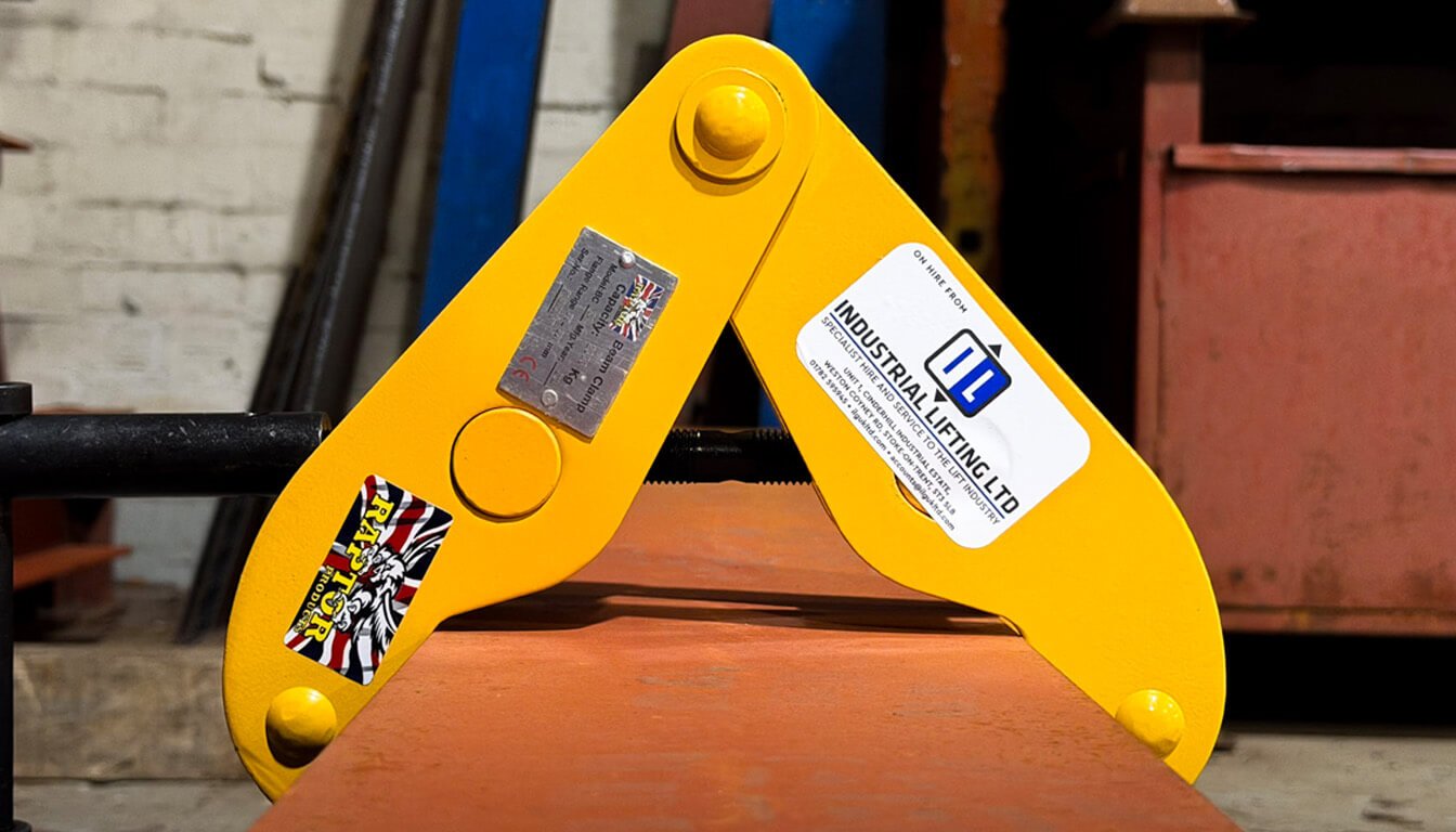 beam clamp hire - Yellow beam clamp on metal surface