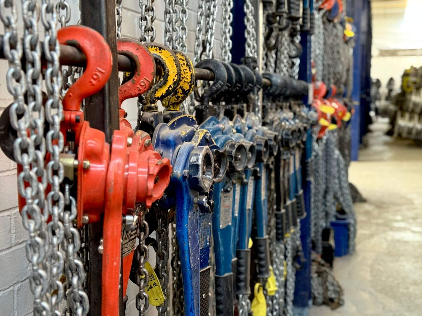 Chain blocks and lever hoists on storage racks at Industrial Lifting, examples of lifting equipment on the 12 month LOLER cycle