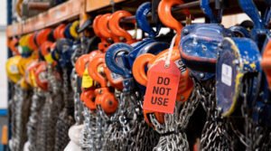 A red "Do Not Use" tag on a chain block, following a failed LOLER inspection at the Industrial Lifting workshop.